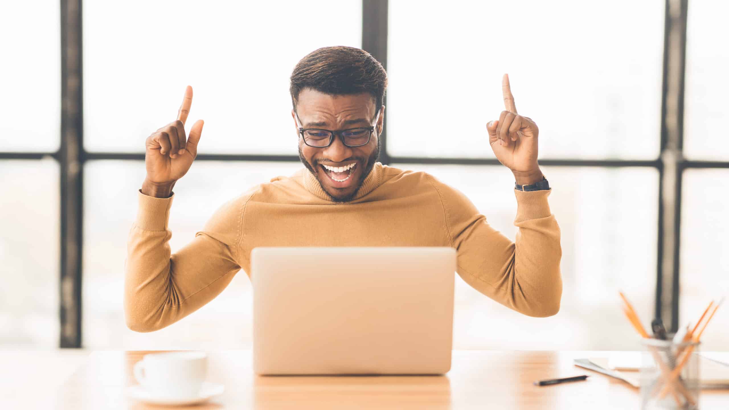 a man happy in front of the laptop