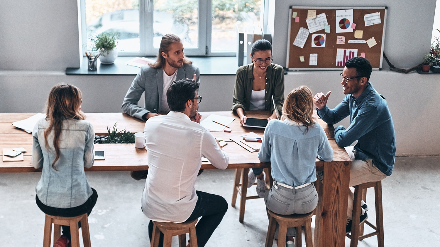 Discussing fresh ideas. Top view of modern young people working together while sitting in the office